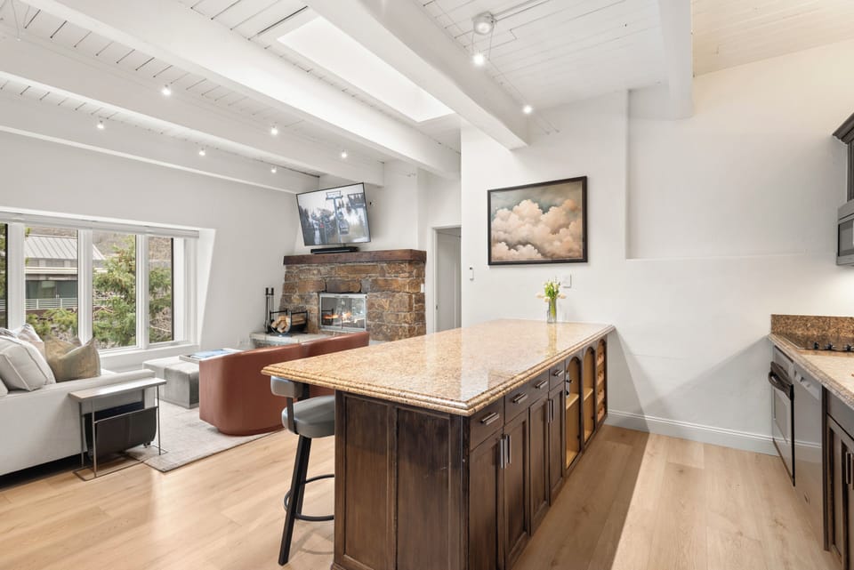 Fully equipped kitchen with seating for 4. The skylights bring in additional natural light and all have electronic blinds if needed.