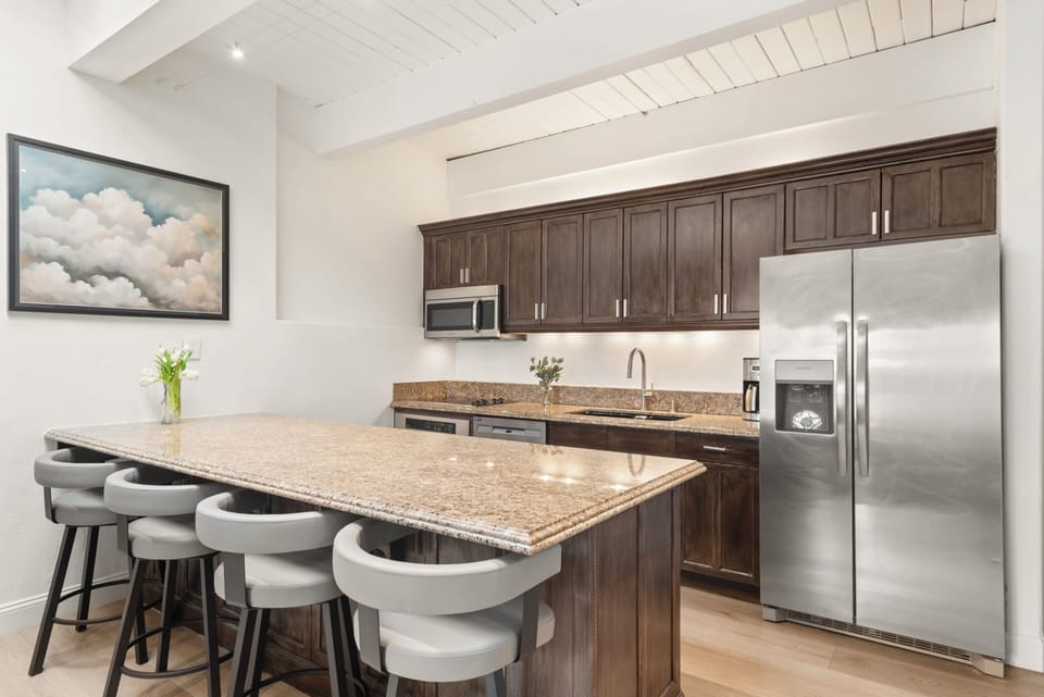 Fully equipped kitchen with seating for 4. The skylights bring in additional natural light and all have electronic blinds if needed.