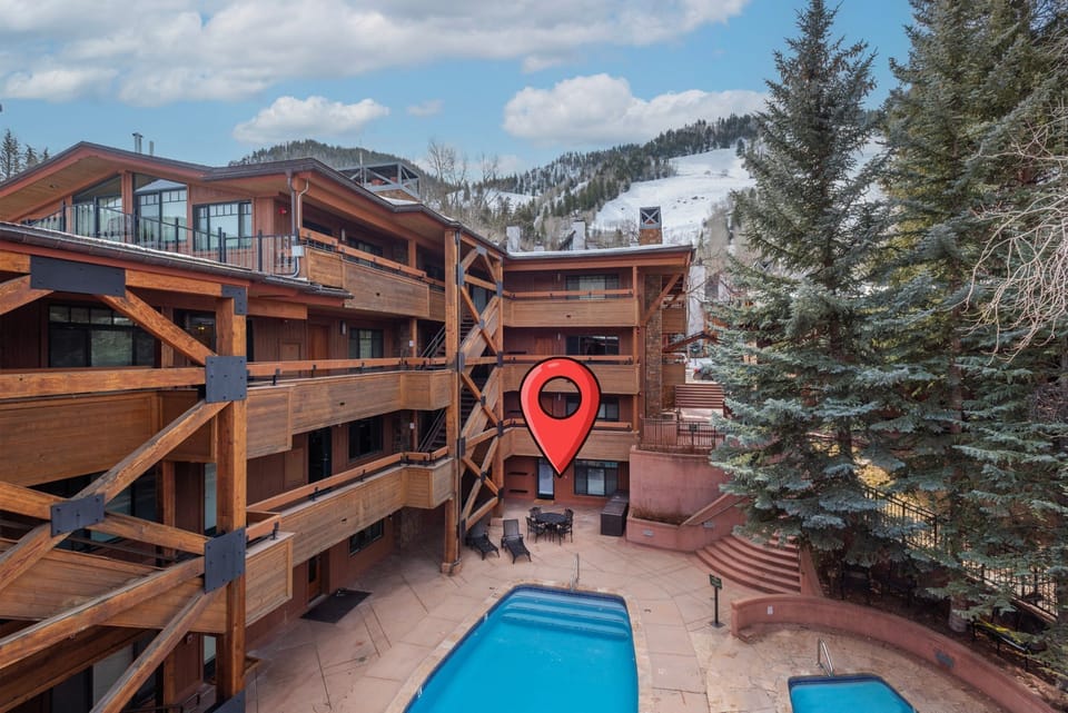 Exterior of the Fasching House Building with the unit on the lower level facing the pool. Great proximity to Ajax Mountain!