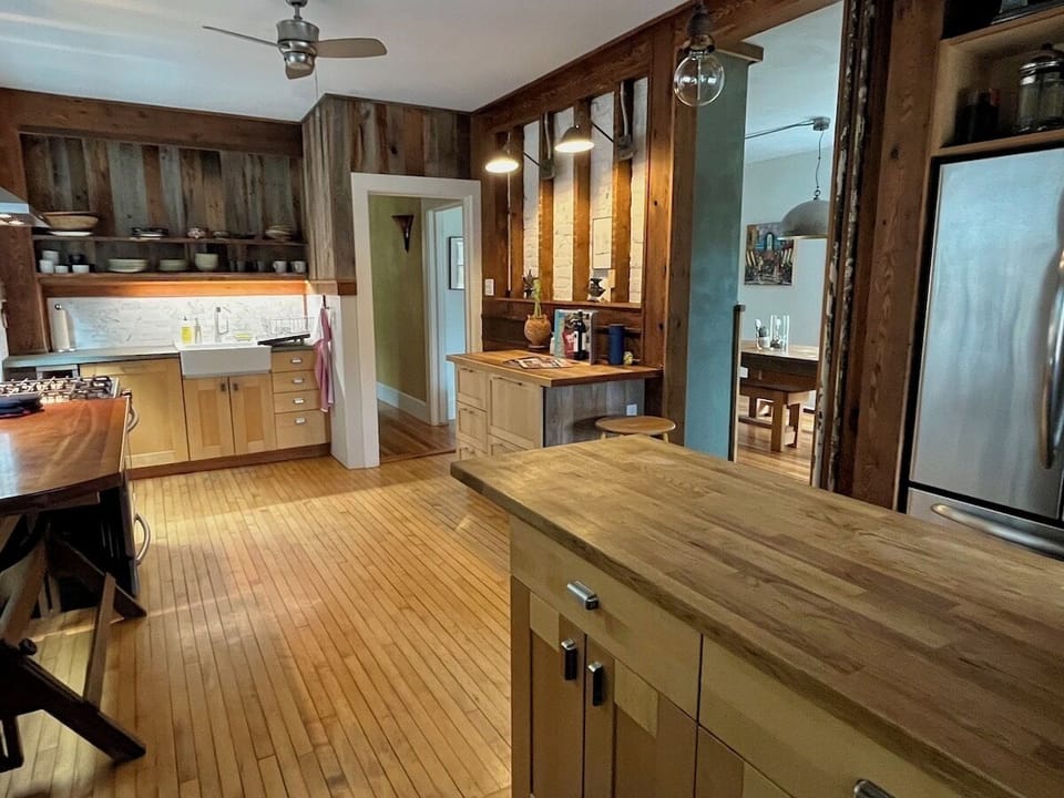 Kitchen leads to dining room, with wood stove