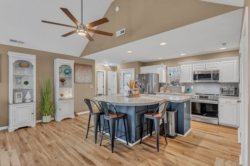 Open kitchen with large island seating, full appliances, and space to gather.