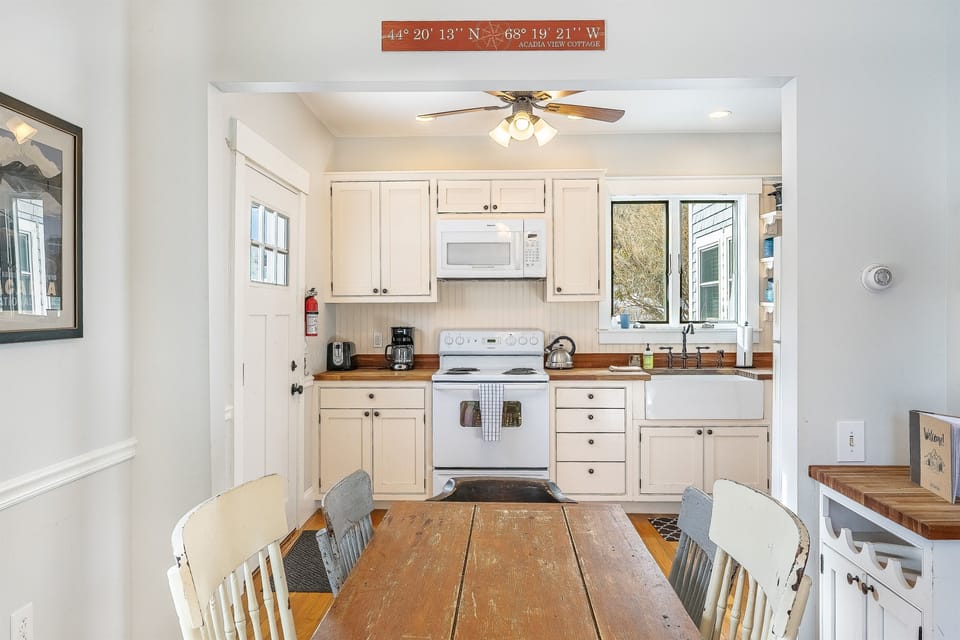 Capture the true essence of MDI with this custom coordinates sign, marking your exact location in Hall Quarry. Our fully equipped kitchen flows seamlessly into the dining area, featuring modern appliances and a coffee station for early island mornings.