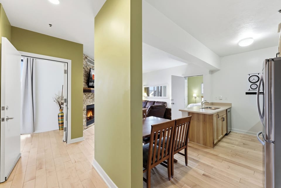 Entry Hallway and Kitchen View:
Interior hallway leading to open kitchen and living space with light wood floors and modern finishes.