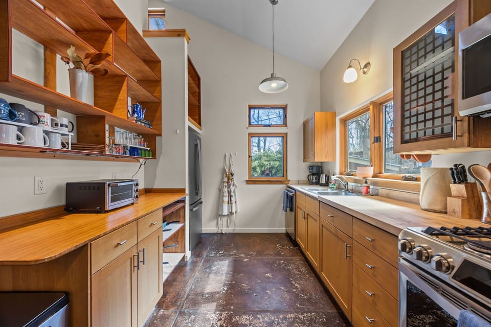 The kitchen is equipped with all the basics needed to prepare meals. A gas range, a drip coffee maker, air fryer, toaster oven, and a kettle complete the kitchen set up.