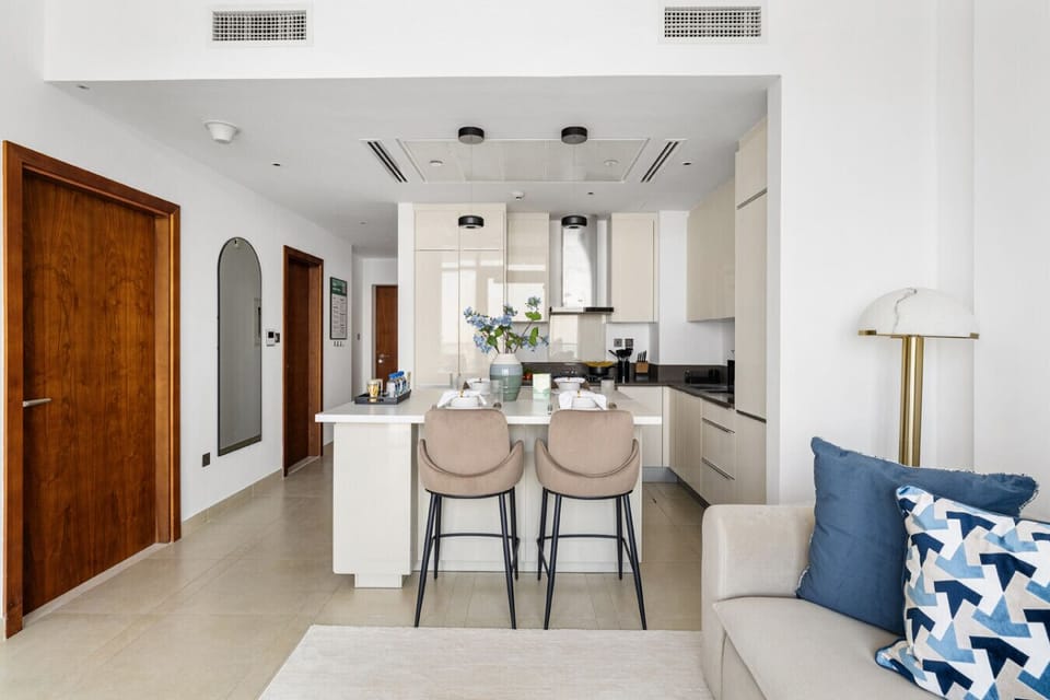 Dining area with open living space and balcony access.