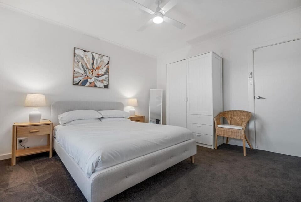 Bright double bedroom with comfortable bedding, storage space, and a relaxing neutral design.