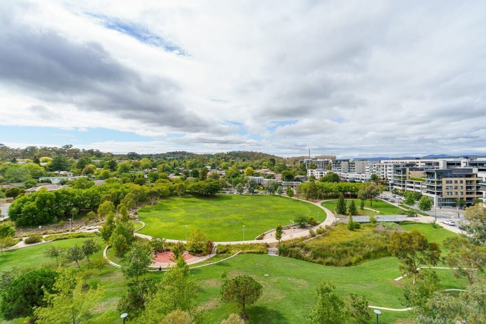 Neighbourhood park with scenic paths and open space for leisure or exercise.