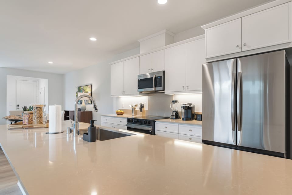 Modern stainless steel appliances and designer backsplashes elevate every meal prep.