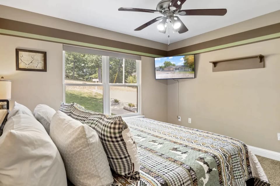 Recharge in the second bedroom, featuring a king-sized bed & smart TV​