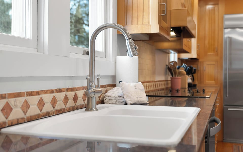 Your fully equipped kitchen features a pull-down faucet, quality appliances, and warm wood cabinetry—perfect for preparing memorable meals.