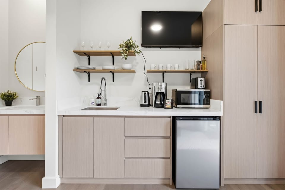 Kitchenette with some clothing storage located near the entrance.