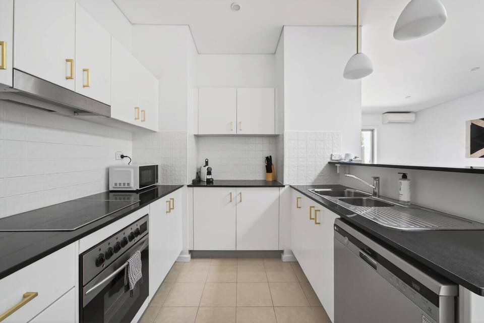 Cook with ease in the contemporary kitchen with everything you might need to whip up a feast, seamlessly connected to the dining and living areas.