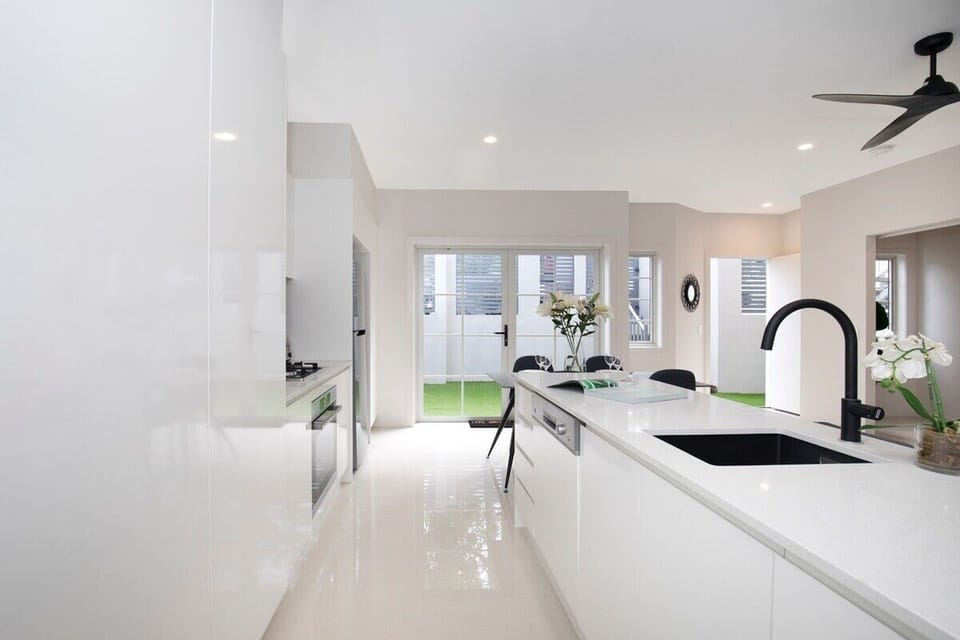 T1 gas kitchen with Bosch appliances, cookware, car park entry and courtyard.