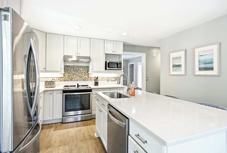 Modern kitchen with stainless steel appliances and a spacious island for family-friendly cooking.