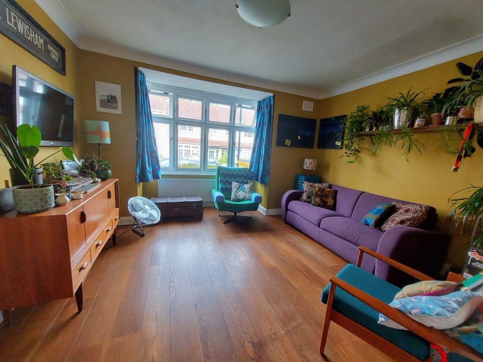 Living room featuring double sofa bed with this, bed standard mattress. 