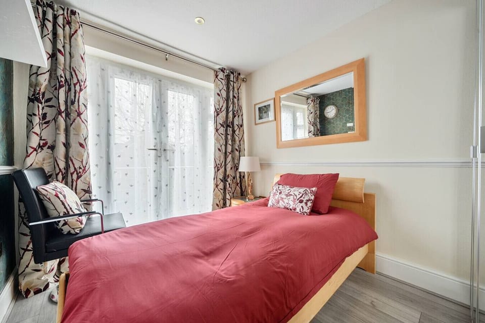Single room with garden-view doors and sheer curtains.