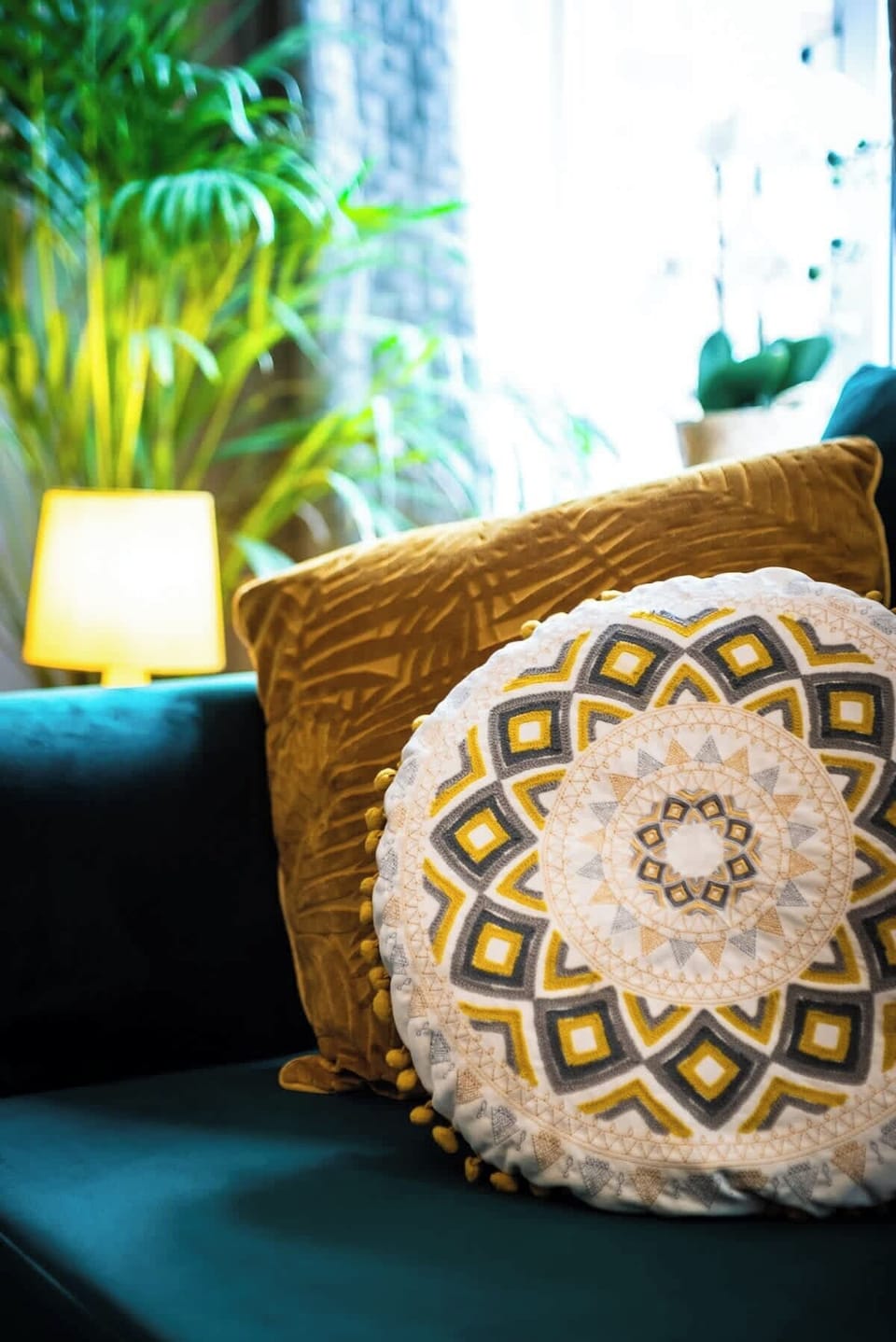 Plenty of cushions and throws for maximum comfort in the living area. There is a door leading to the conservatory and garden. TV present on opposite wall at Blue Puffin Stays Short Lets & Serviced Accommodation