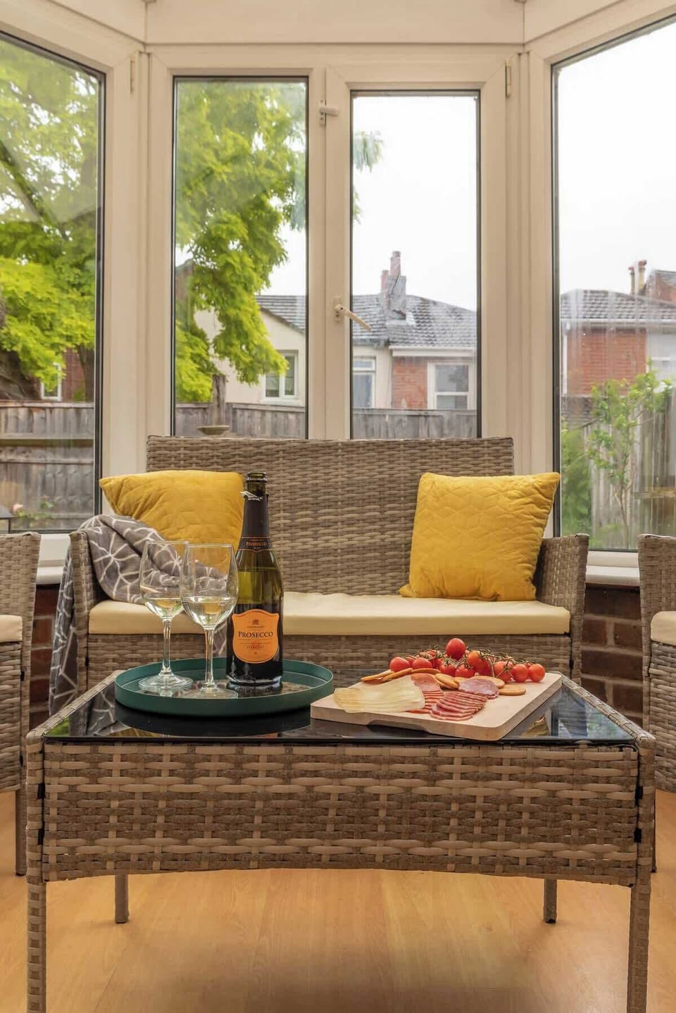 Rattan furniture for relaxing in summer or winter. Conservatory relaxation area at Blue Puffin Stays Short Lets & Serviced Accommodation.