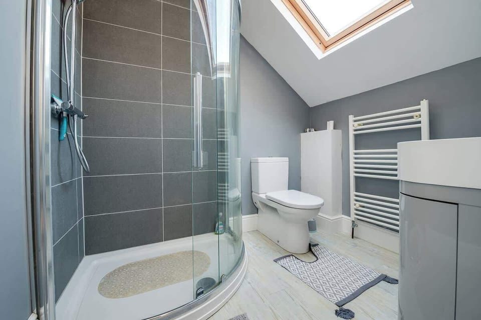 Enjoy a rejuvenating shower in the master bathroom with walk-in shower offering ultimate relaxation and tranquility at Blue Puffin Stays Short Lets & Serviced Accommodation.
