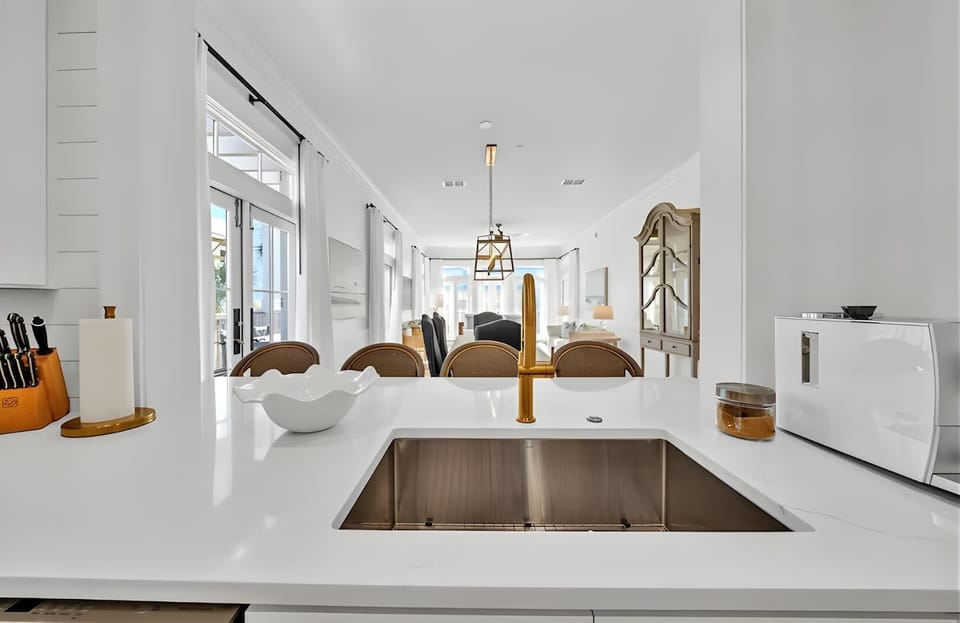 Sleek fixtures and a deep stainless sink make meal prep a truly gourmet experience.