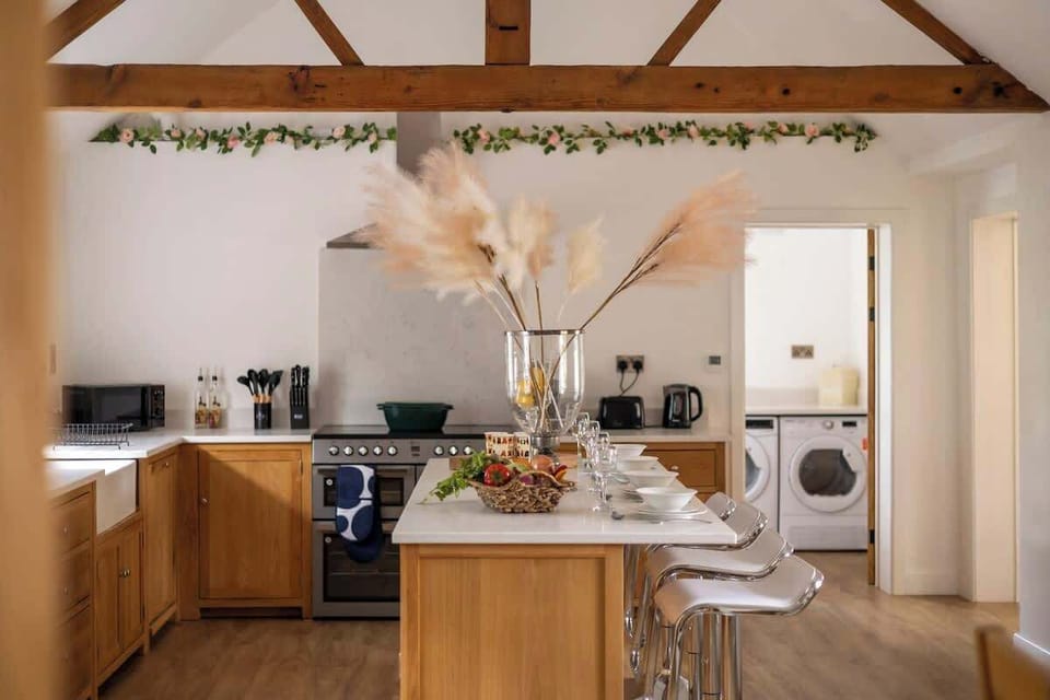 Cook up a storm in this charming barn-inspired kitchen, featuring warm wooden finishes, modern appliances, and plenty of counter space. The perfect blend of rustic character and contemporary convenience makes every meal feel cozy and inviting.