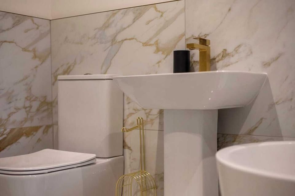 Sleek, modern bathroom designed for comfort and convenience. Enjoy a full-sized shower or a relaxing soak in the bathtub, with crisp, clean finishes, and contemporary fixtures. Every detail is crafted to make your stay feel effortless and luxurious.