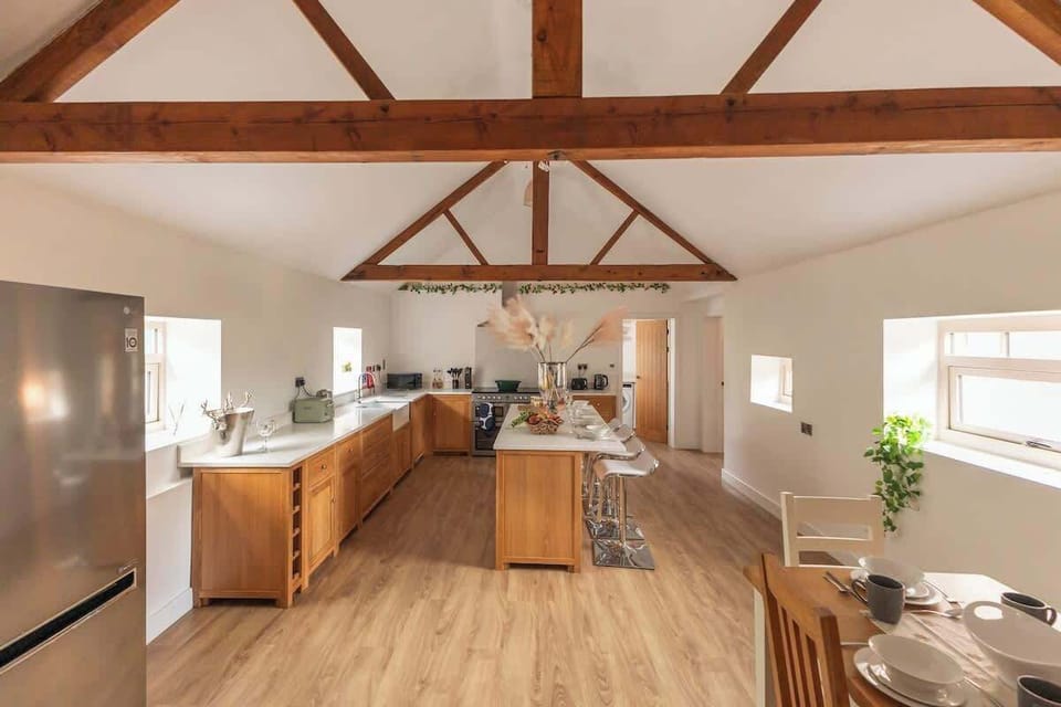 Cook up a storm in this charming barn-inspired kitchen, featuring warm wooden finishes, modern appliances, and plenty of counter space. The perfect blend of rustic character and contemporary convenience makes every meal feel cozy and inviting.