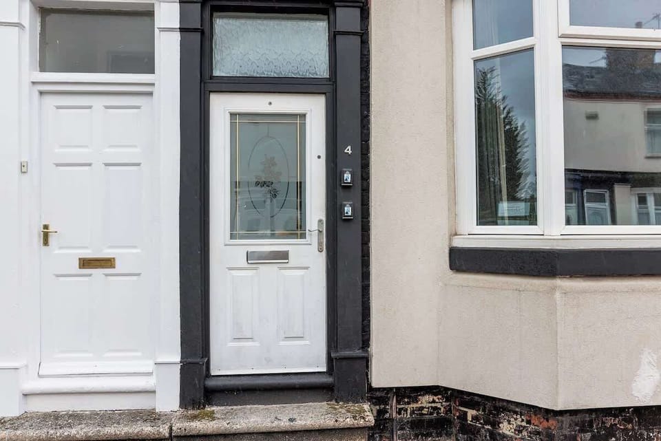 A welcoming entrance with a charming front door and easy access to the property.