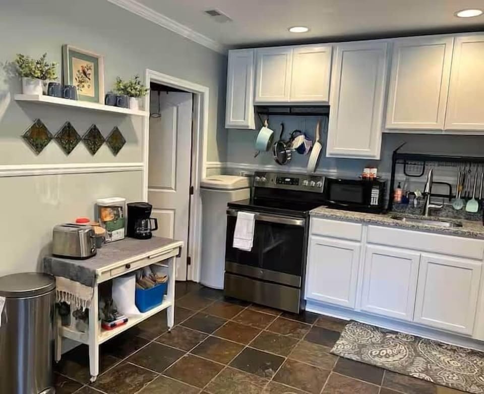 Full Kitchen with Stove, Microwave, Water Heater, and Coffee/Tea Bar.  