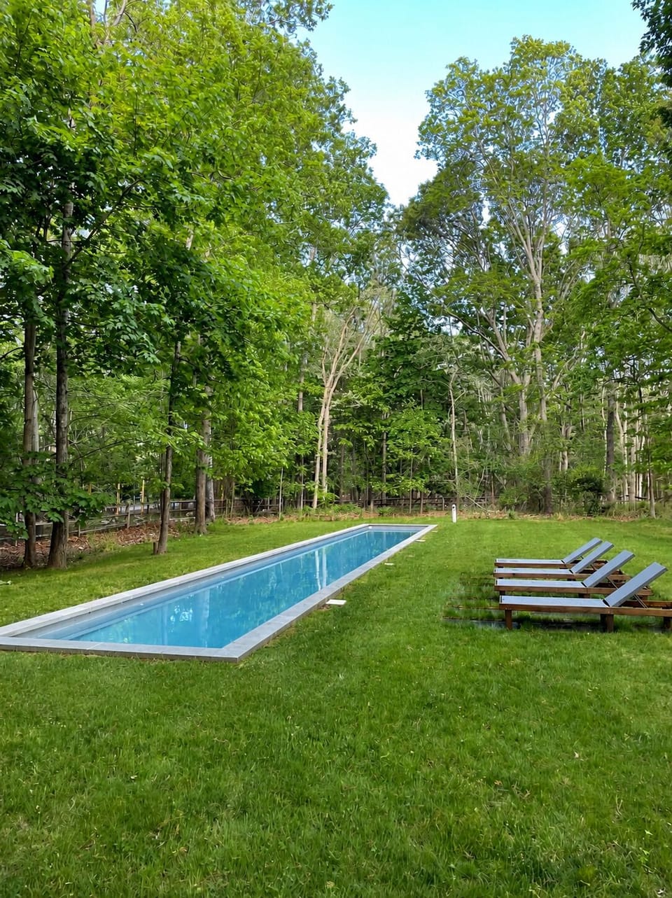 Your private summer oasis, complete with a pristine pool and loungers.