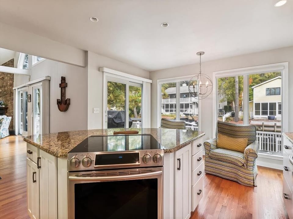 The open-concept design of the kitchen and living area invites family interactions, complete with cozy seating and radiant light, embodying the essence of relaxed coastal living.