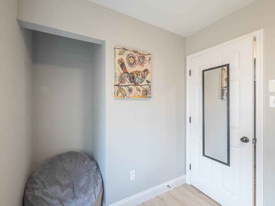 A corner of the home showcases a whimsical piece of artwork and a cozy beanbag, adding a touch of comfort to the space.