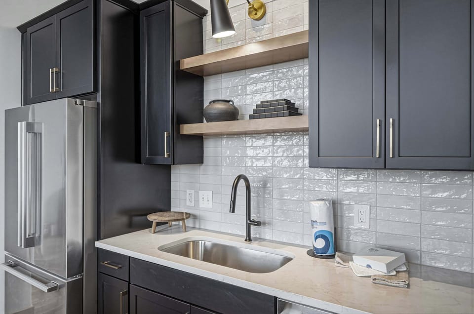 
A streamlined sink framed by bold cabinetry, where form meets effortless function.