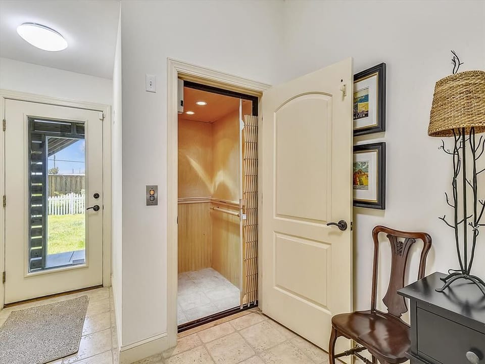 A convenient in-home elevator provides easy access to all levels, combining luxury with practical coastal living.
