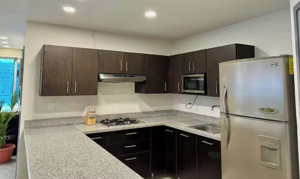 Modern kitchen w/ sleek cabinets, stainless appliances & bright workspace