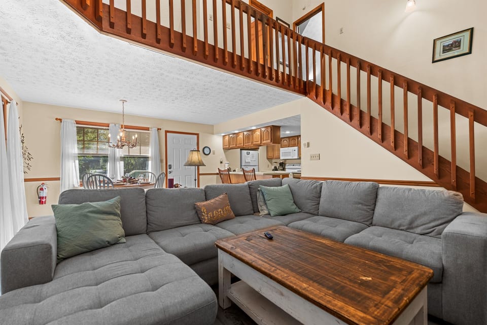 Open living space with large sectional seating and an easy flow into the dining area and kitchen—great for relaxing together after a busy day out. More room to spread out, watch TV, and spend time as a group than a typical hotel stay.