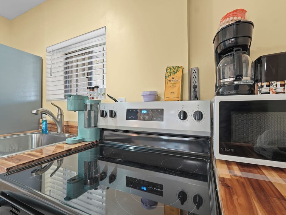 glass stove top with oven, microwave, toaster, 2 coffee makers