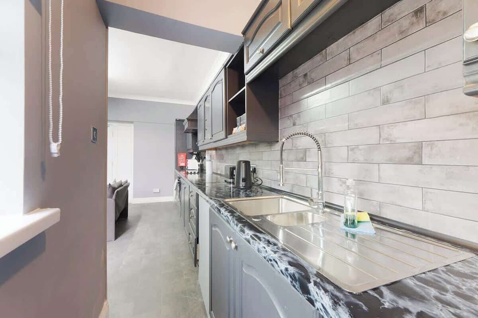 Kitchen equipped with all essentials, including an oven, fridge, and full cookware set.