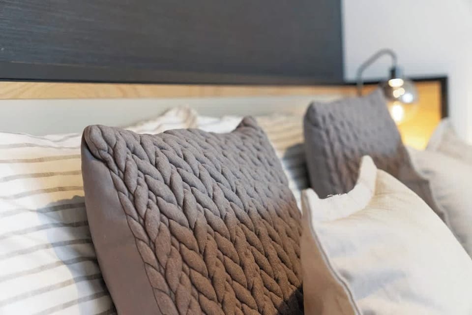 Bedroom 1 offers flexibility and comfort with a cosy double bed and a dedicated workspace area, ensuring a restful retreat for a peaceful night's sleep.