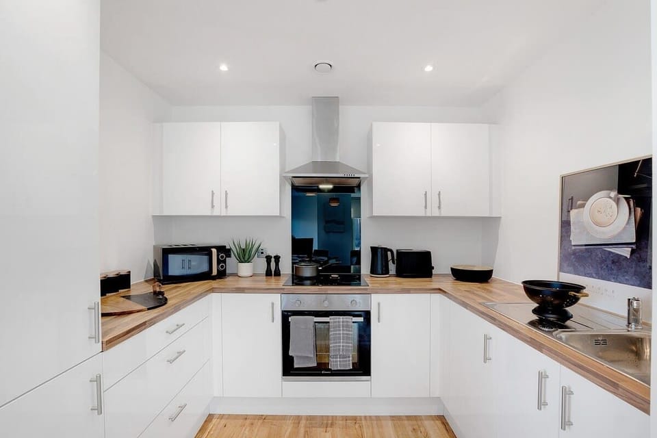 Kitchen equipped with all essentials, including a washer & dryer, oven, fridge and full cookware set.