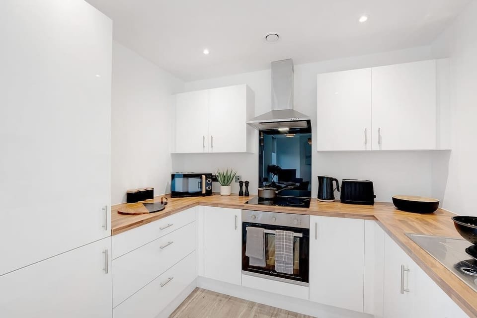 Kitchen equipped with all essentials, including a washer & dryer, oven, fridge and full cookware set.