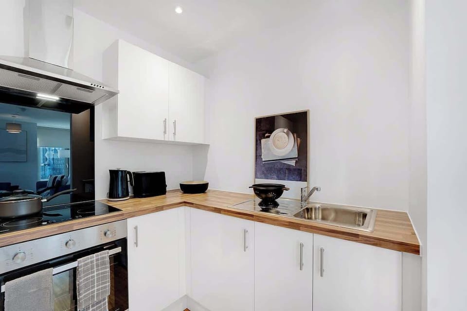 Kitchen equipped with all essentials, including a washer & dryer, oven, fridge and full cookware set.