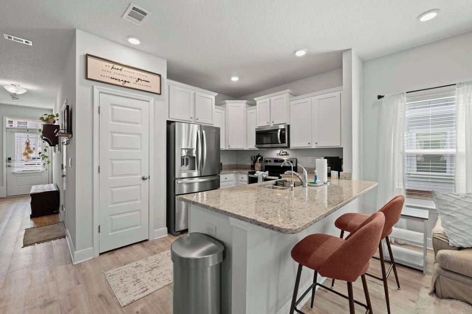 Cook, dine, and unwind in a spacious, open-concept kitchen and living area.