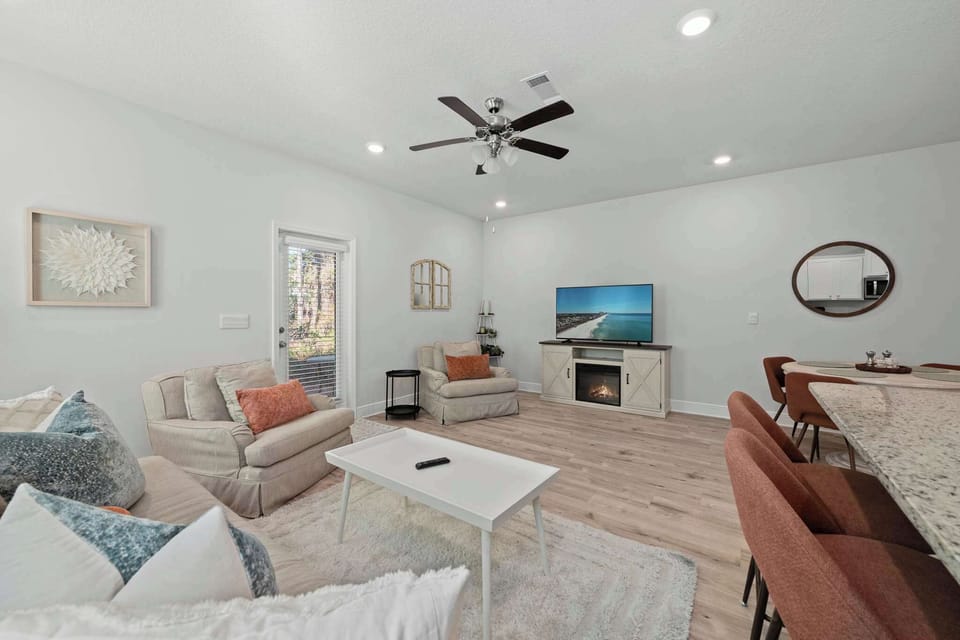 The living area features a super cozy couch and two inviting reading chairs.