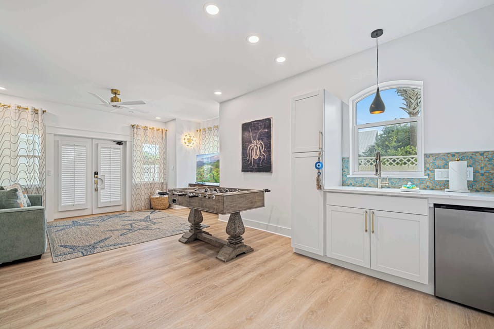 This living room is complete with a kitchenette with a mini fridge, and a foosball table for friendly competition!