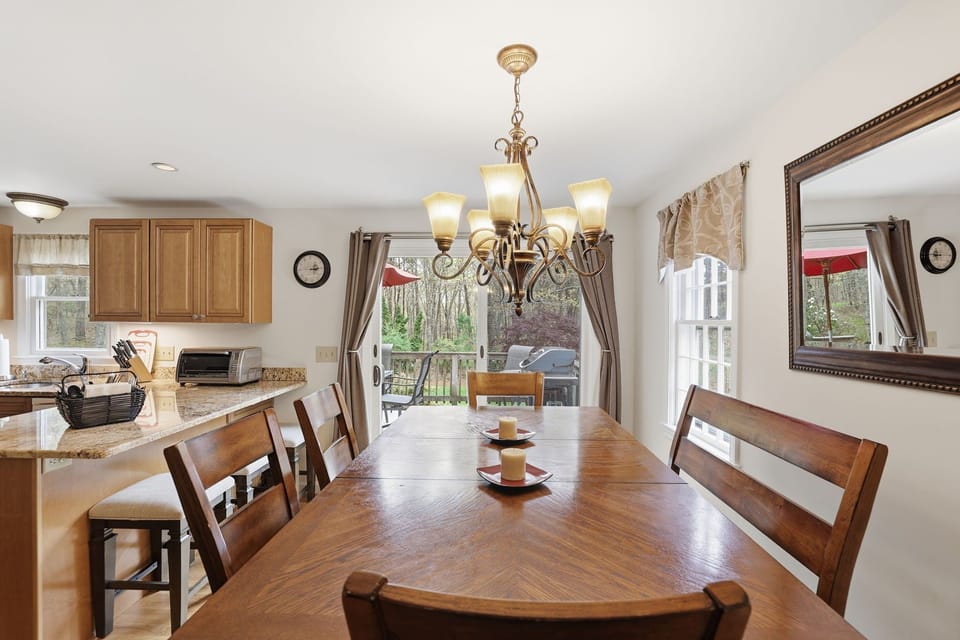 Sunlit dining for 6 with outdoor access.