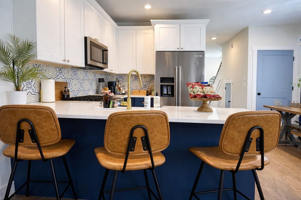 The island seats 3 with extra dining space for easy gatherings.