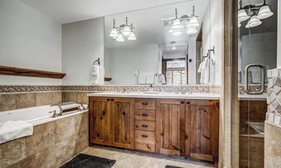Refresh in our spacious bathroom, offering a double vanity, large tub, and elegant fixtures. A serene space for relaxation and self-care.