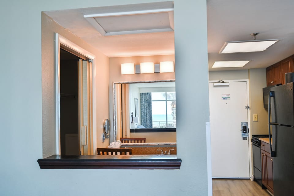 Vanity area with large mirror, bright lighting, and space to get ready easily