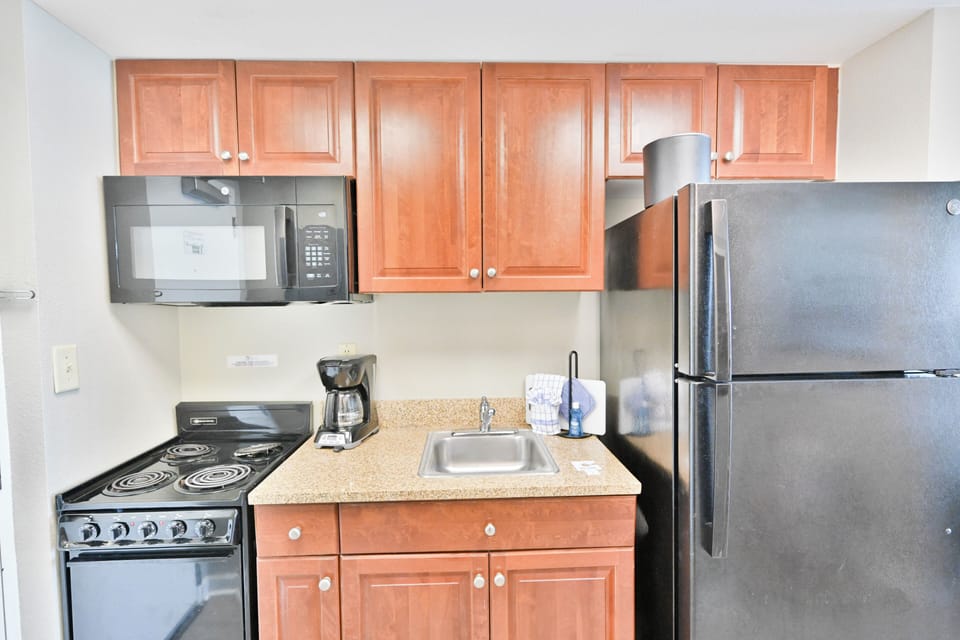 Includes a full-sized refrigerator, oven/stovetop, microwave, and coffee maker.